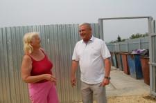 Глава поселка Октябрьский А. П. Кривегин и жительница села В. В. Мезенцева возле вновь оборудованной мусорной площадки